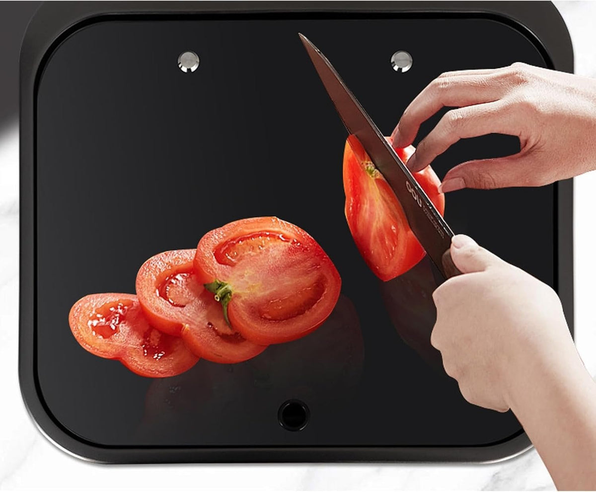 Black tempered glass cover of the sink used as a cutting surface