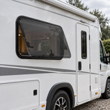 VanShade window installed on a flat motorhome wall — illustration